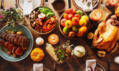 Friends gathering around a dinner table for a feast